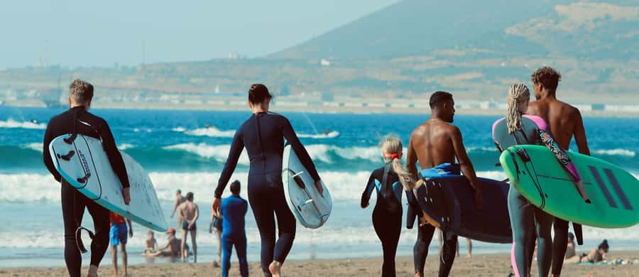 Agadir: 2h Surf Lesson with Local Instructors - Moving into the water with an instructor nearby