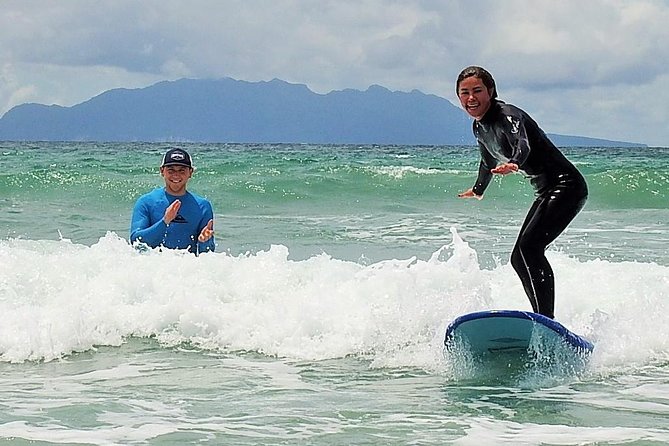 Beginner Surf Lesson at Te Arai Beach - Taking the board into the water