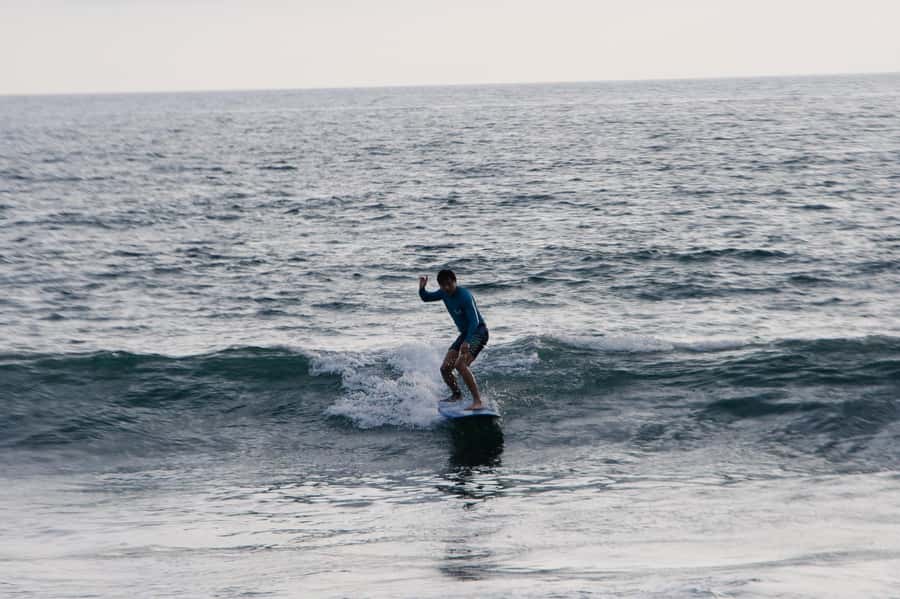 Beginner Surf Lessons in Canggu - Heading into the water with an instructor beside you