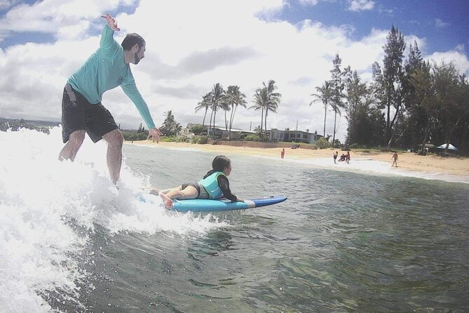 Group Surf Lessons for beginners on the North Shore of Oahu - Catching small waves on the North Shore