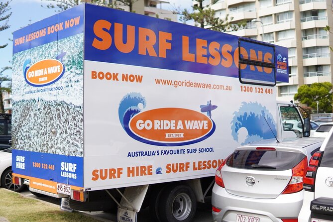 Learn to Surf at Coolangatta on the Gold Coast - Catching small waves in waist-deep water