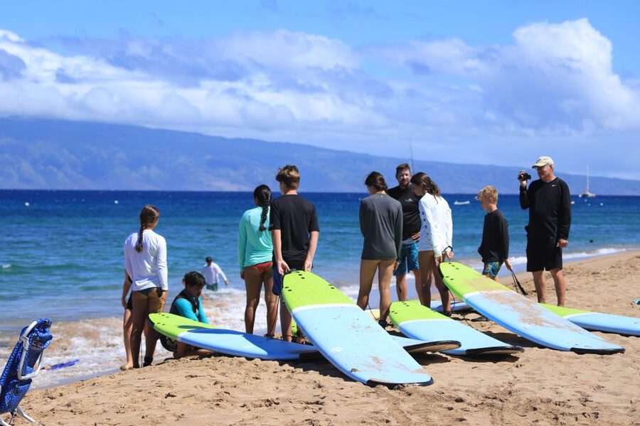 Maui: Group Surf Lesson - Walking from the sand into the Pacific