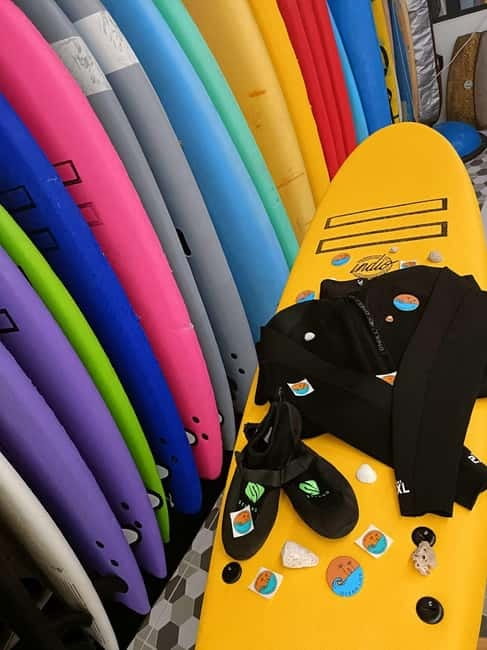 Playa de Las Américas: Premium Surf Equipment for Rent - Picking up your board under the blue BBVA sign
