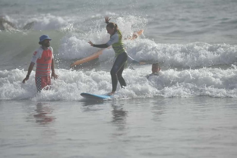 Playa de Las Americas: Surfing Lesson with Photo Analysis - Moving into the water with an instructor nearby