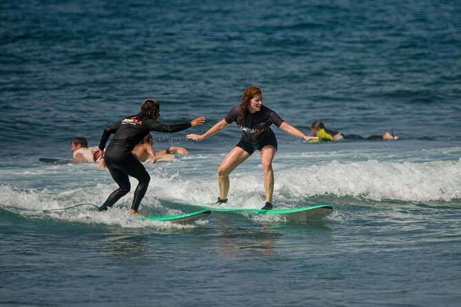small group surf lesson in Playa de las Américas,Tenerife - The instructors: David, Davide, Vicky, and Victoria