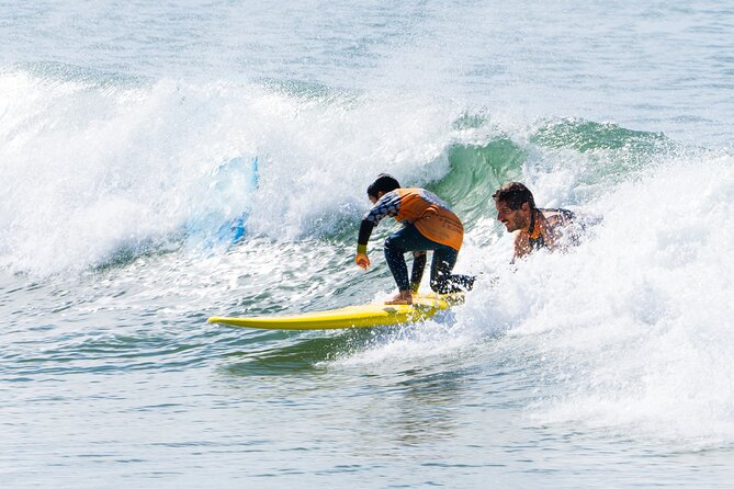 Surf Lessons Cascais and Lisbon - Warm-up, swimming, and the first attempts